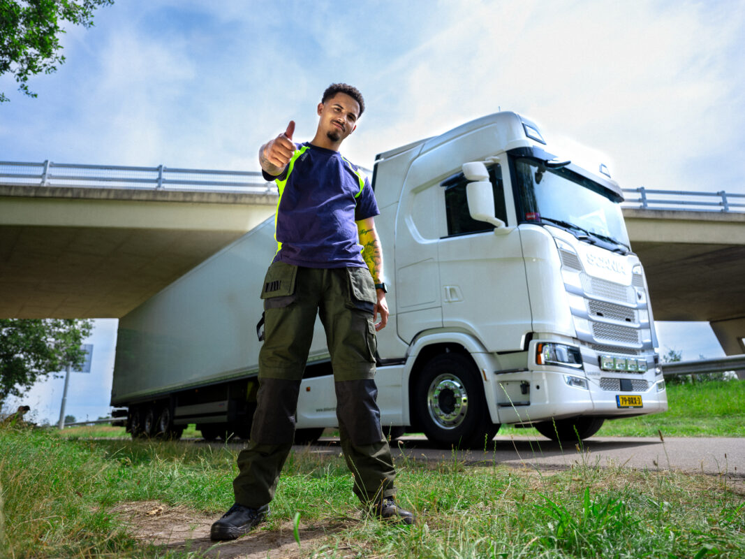 Man before truck with thumb up